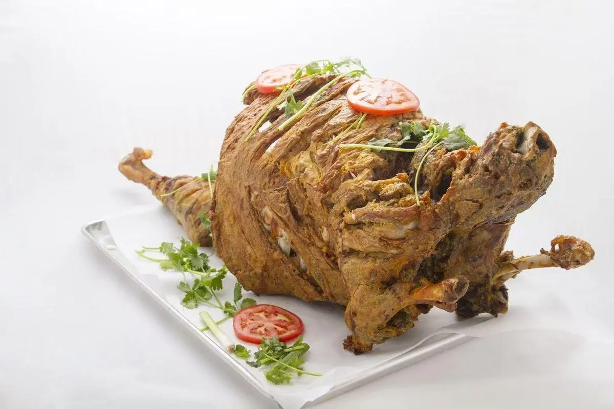 Whole roasted lamb leg with herbs at Bogda Uyghur Restaurant, a Central Asian Halal Restaurant in Plano