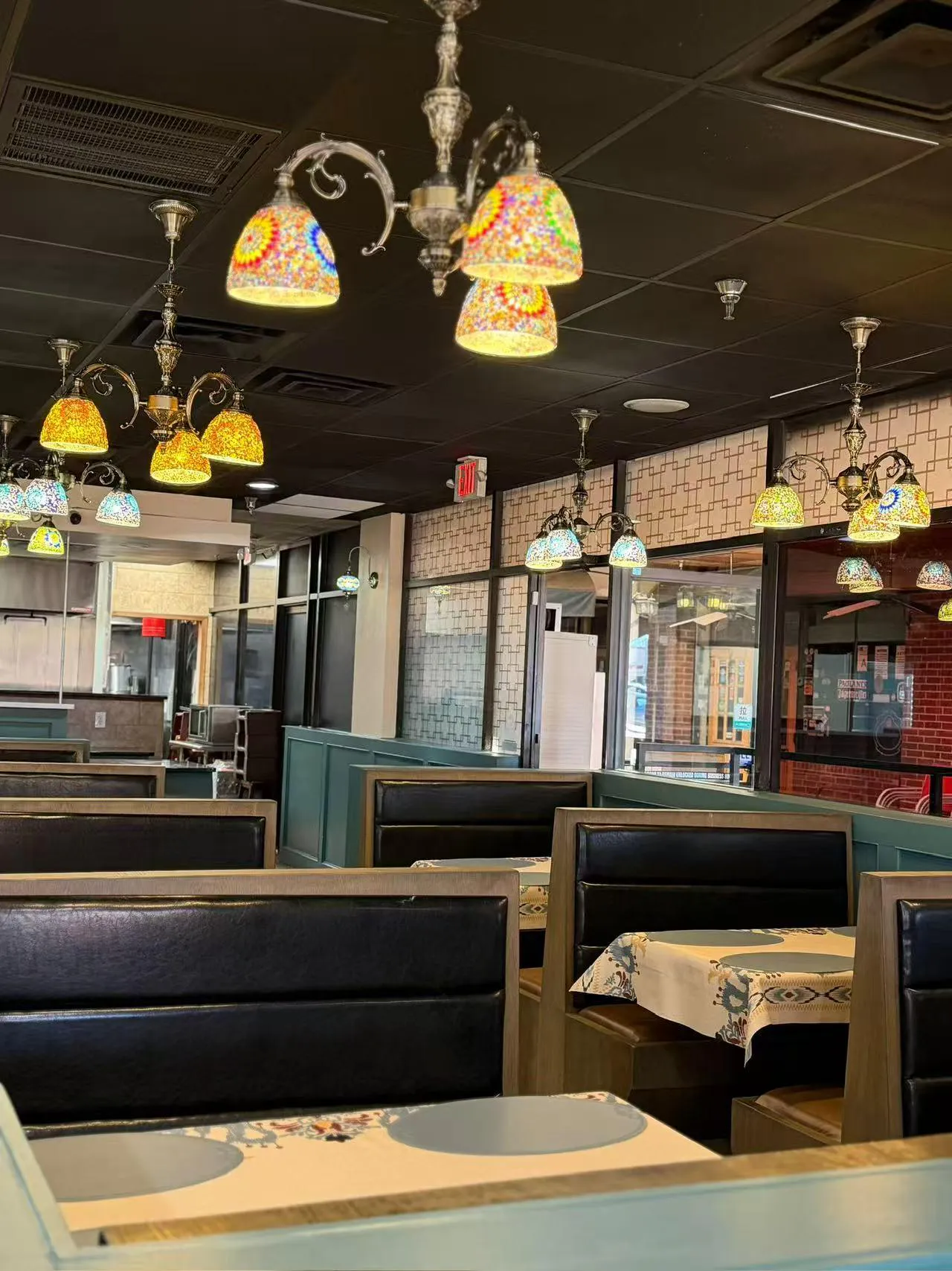Cozy restaurant dining interior with mosaic lamps at Bogda Uyghur Restaurant, a Central Asian Halal Restaurant in Plano